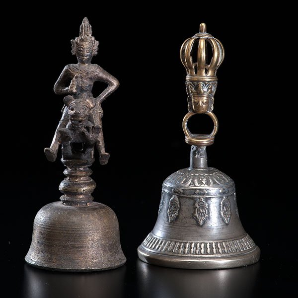Pair of Temple Bells : Pair of Temple Bells Indian and Nepalese, 19th century. Two bronze altar bells. One bell is from India, representing a man on a tiger. The other bell is from Nepal, with a crowned head carved in the
