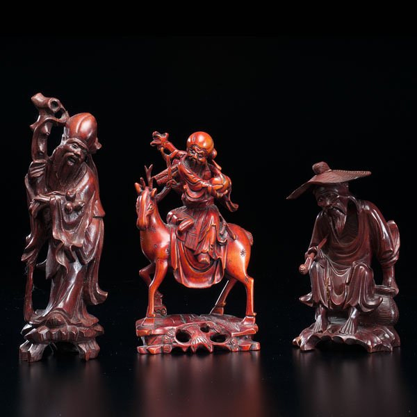 Three Wood Sculptures of Deities : Three Wood Sculptures of Deities Chinese, 20th century. One wood sculpture of an old man holding a pipe. 9 x 19 in. One wood sculpture of Lohan, God of Longevity. 3 x 10 on. One wood sculpture of Ca