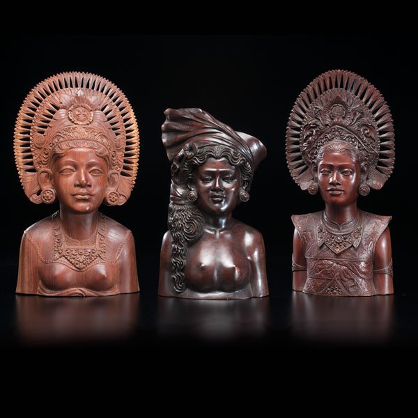 Three Female Busts : Three Female Busts Indonesian, late 19th century. Three carved polished wood sculptures of women's busts. Two display a traditional headdress, one shows a tied scarf headdress with flowers. All thre