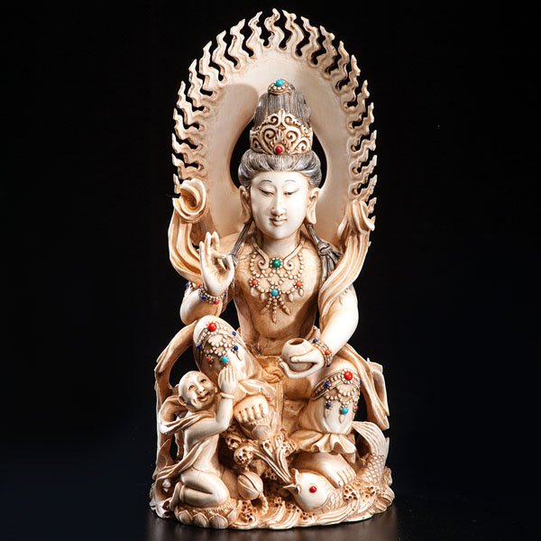 A Chinese Ivory Carving of a Deity : A Chinese Ivory Carving of a Deity Chinese, 19th century. A carving of a Buddhist deity with a Tibetan influence, signaled by the polychrome beads adorning the figure. The deity is sitting, resting 