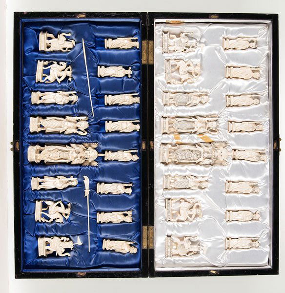 A Chinese Carved Ivory Chess Set : A Chinese Carved Ivory Chess Set Early 20th century. A set of large carved ivory chess pieces, contained in a wood box and board. Ht.: 7 in. (largest ivory piece); 23 x 11.5 (box dimensions).