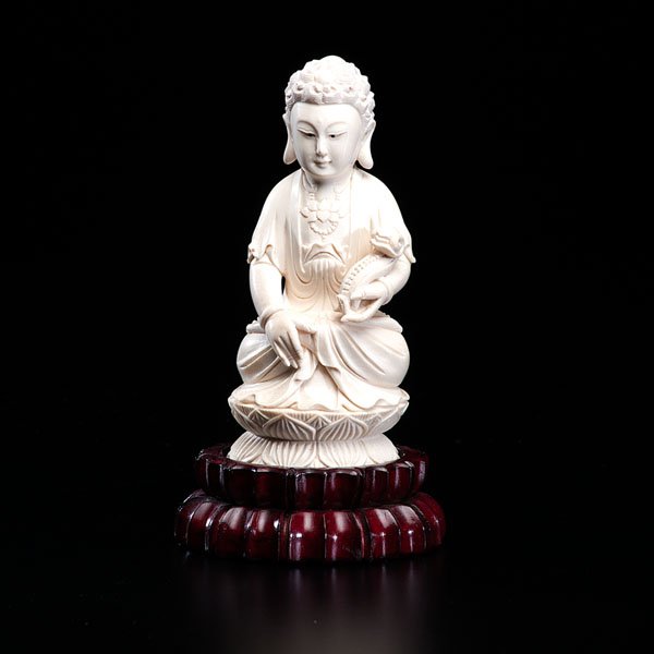 Chinese Ivory Carving of a Seated Buddha : Chinese Ivory Carving of a Seated Buddha Early 20th century. A carved ivory Buddha figure, seated on a lotus throne, resting on a wood stand. Ht.: 6.25 in. Provenance: Private Collection, Holl