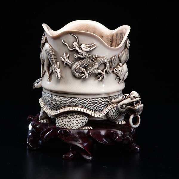 Chinese Inked and Carved Ivory Vessel : Chinese Inked and Carved Ivory Vessel 19th century. An inked and carved ivory vessel in the shape of a dragon, and decorated with relief animal motifs, such as monkeys, rats, pigs, dragons, horse