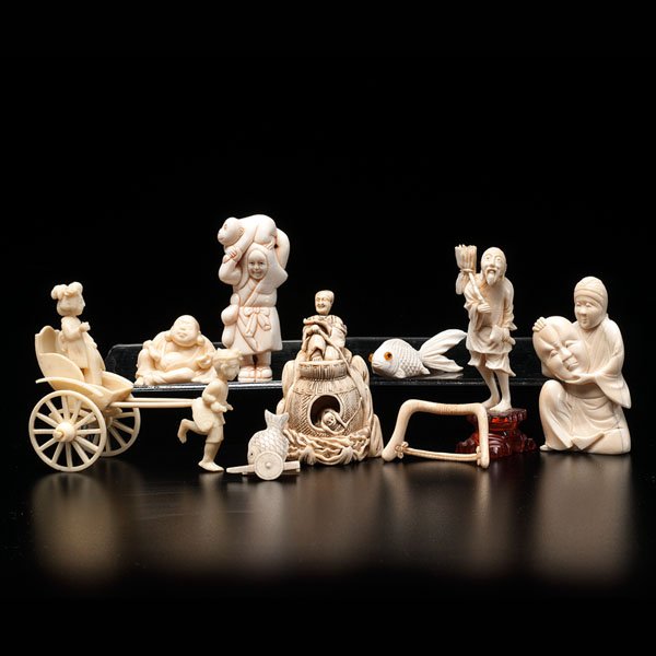 Miscellaneous Japanese Ivory Carvings : Miscellaneous Japanese Ivory Carvings Late 19th/early 20th century. A group of nine ivory carvings, including a man with a mask, a man with a monkey, a man sitting on a throne, a woman on a cart d