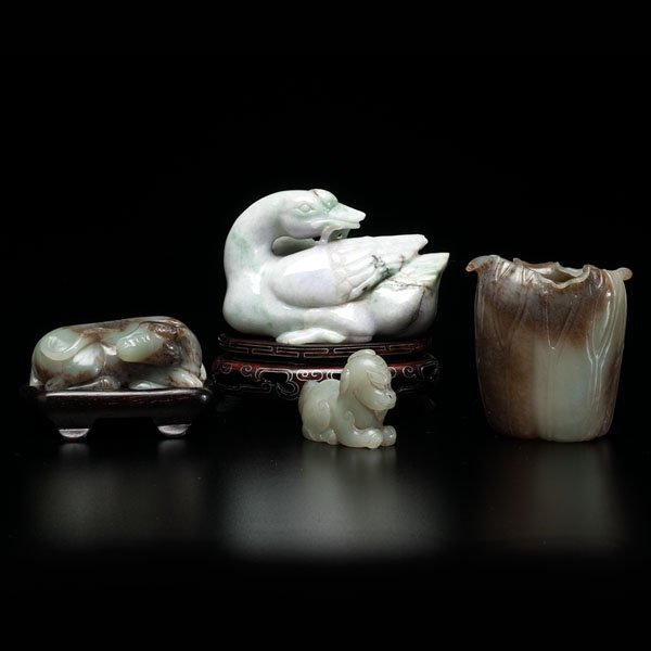Chinese Jade Carvings : Chinese Jade Carvings Chinese. A group of four Chinese jade carvings, including a water buffalo, well polished and on stand, having russet inclusions, a lotus pod for brush washer, a jadeite duck on