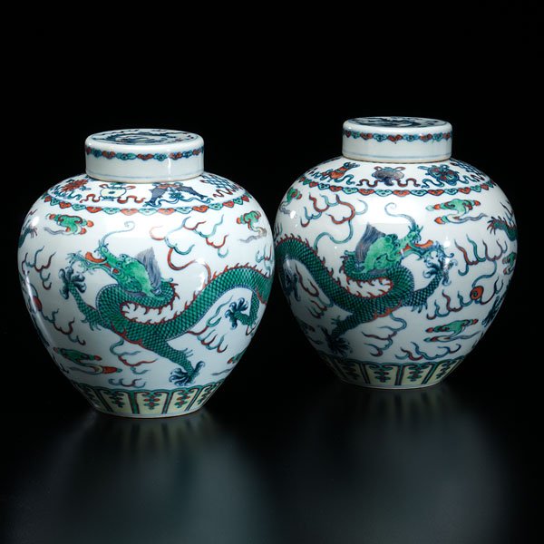 Pair of Chinese Dragon Decorated Covered Jars : Pair of Chinese Dragon Decorated Covered Jars Chinese, late 19th century. A pair of dragon-decorated porcelain covered jars. Each with Qianlong mark to underside; ht. 8.75 in. (each).