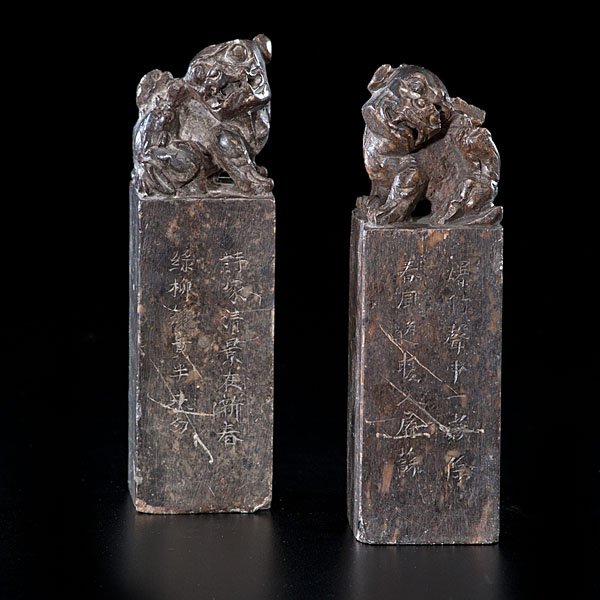 Pair of Chinese Soapstone Seals : Pair of Chinese Soapstone Seals Chinese, early 20th century. A pair of soapstone seals, each with Foo dog finials carved on top, each with inscriptions on the front side. Ht. of each 7 in.