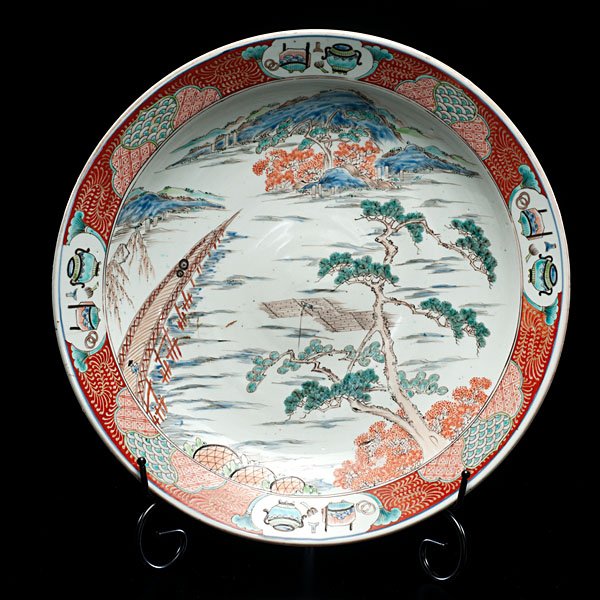 Japanese Imari Scenic Charger : Japanese Imari Scenic Charger Japanese, 1880. An Imari charger with decorations of a water view landscape with a bridge, border with reserves of the "One Hundred Antiques." Archaic mark to undersi