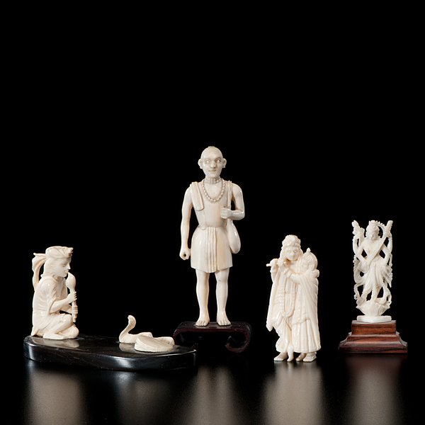 Collection of Indian Ivory Figures : Collection of Indian Ivory Figures Indian, early 20th century. Four well-carved ivory figures including a snake charmer, a Bodhisattva, a standing male figure with shoulder bag, and a man and wom