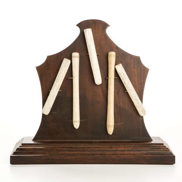Whale Bone Clothespins : Whale Bone Clothespins American, 19th century. A group of five whale bone clothespins mounted on shaped wooden stand; stand ht. 11 in, longest pin lg. 6.25 in.
