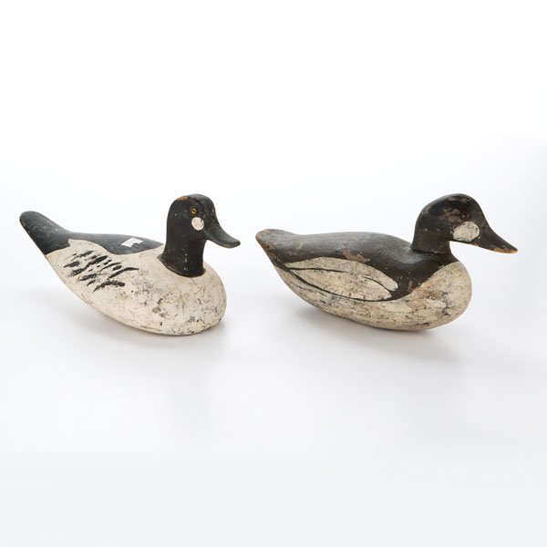 Goldeneye Duck Decoys : Goldeneye Duck Decoys American, 20th century. Two carved goldeneye duck decoys, having delineated beaks, tack eyes, and polychrome painted details, colors include black, white, yellow, and blue, one