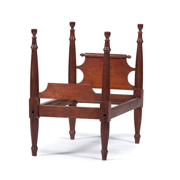 Miniature Four-Poster Bed in Walnut : Miniature Four-Poster Bed in Walnut American, 19th century. A miniature four-poster bed in walnut with turned feet, turned posts with finial tops, a shaped footboard, and a shaped headboard with a t
