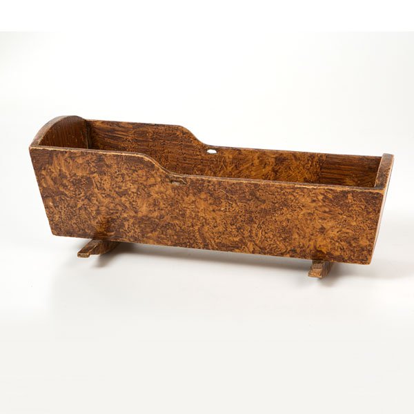Paint-Decorated Doll Cradle : Paint-Decorated Doll Cradle American. A paint-decorated doll cradle with faux graining, having shaped sides with a cut out on each, shaped rockers and nailed construction, written in pencil on under