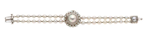 A Vintage 14 Karat Lucien Piccard Pearl Bracelet Watch : A vintage, ca 1960, Lucien Piccard 14k white gold bracelet watch with a hidden dial featuring 18 VS1, H-I color single cut round diamonds weighing approximately .25 carats total weight surrounding an