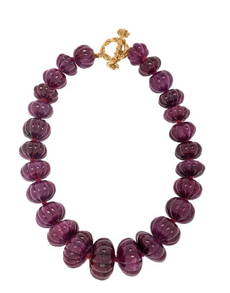 Mish of New York Hibiscus Ruby Bead Necklace : Mish of New York 17" ruby bead necklace with an 18 karat yellow gold hibiscus design toggle closure. Ruby beads range from 17mm to 28mm. Hand strung and knotted. 17 in. length
