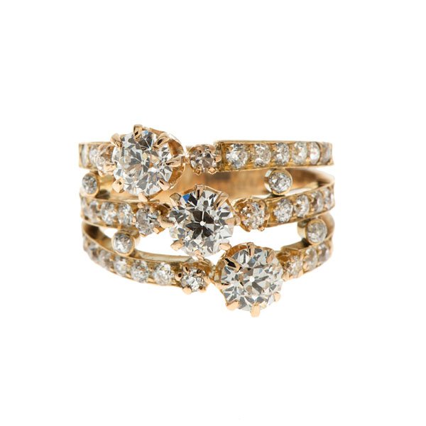 Antique 14 Karat Triple Solitaire with Diamonds : A vintage 14k yellow gold ring containing 34 SI1- SI2, G-H color European cut diamonds weighing approximately .60 carats total weight and three SI1-SI2, H-I color European cut diamonds weighing approx