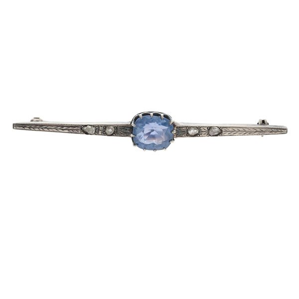 Victorian Era Sapphire and Rose Cut Diamond Pin : A heavy Victorian-era silver pin featuring a 9.3mm x 8mm x 5.55mm cushion cut blue sapphire weighing approximately 3.5 carats and four rose cut diamonds as accents. Hand engraved. 4.0 dwt. 2 in. lengt