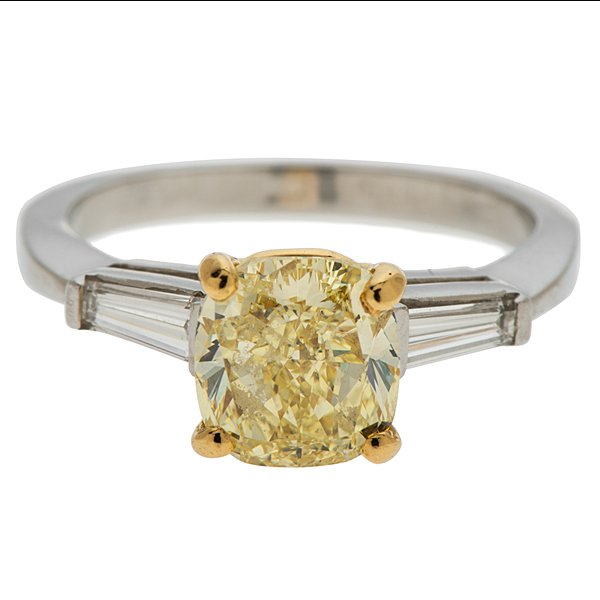 A Platinum and 18 Karat Yellow Gold G.I.A. Certified: A platinum ring featuring a 7.77mm x 7.37mm x 4.72mm cushion cut SI1 fancy yellow diamond weighing 2.37 carats set in an 18 karat yellow gold head and 2 VS1, G-H color tapered baguettes weighing appro