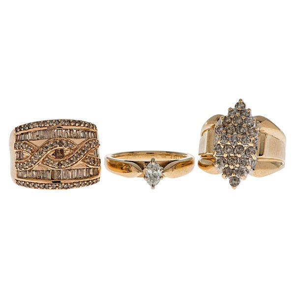 A Trio of Diamond Rings : A grouping of three yellow gold rings. One 14 karat cathedral solitaire containing one SI1, G-H color marquise diamond weighing .37 carats; one 10 karat yellow gold cluster containing 23 I1-I2, K-L co
