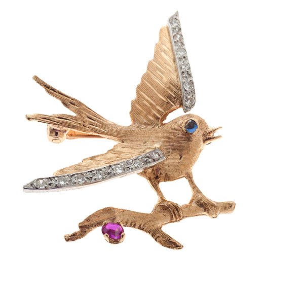 A 14 Karat Swallow on a Berry Branch Brooch : A 14k yellow gold brooch depicting a swallow on a berry branch containing 13 single cut accent diamonds set in white gold plates, one 1mm round sapphire eye and one 2.5mm x 2mm oval cabochon ruby "ber
