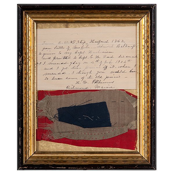 Pieces of Flag from the USS Hartford : Largest section (red) roughly 4 x 8 in., framed, 10.5 x 12.5 in. Inked note is written and signed by H.W. Polhemus of Richmond, ME, explaining that the three pieces are from a flag flown on the USS Ha