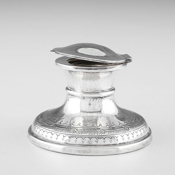 Birmingham Sterling Inkwell : Birmingham Sterling Inkwell British, early 1920s. A Birmingham sterling silver inkwell, made by Liberty and Co. Round-shaped, lidded, and with a wooden underside, the inkwell is decorated with in