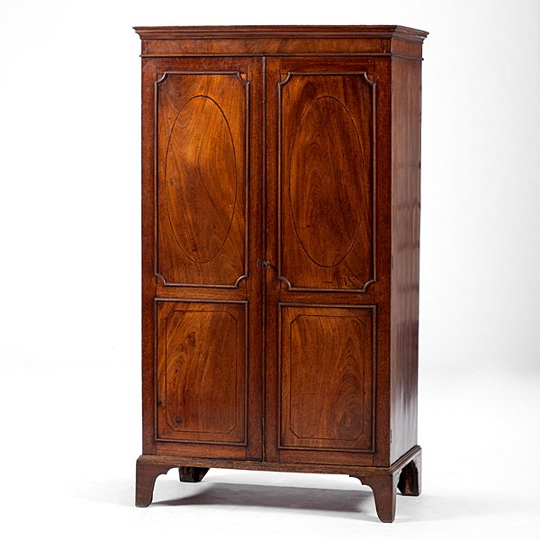Diminutive English Armoire : Diminutive English Armoire English, 19th century. A diminutive armoire in mahogany, having a molded cornice over a pair of paneled doors decorated with bands of inlay forming ovals and shields, 