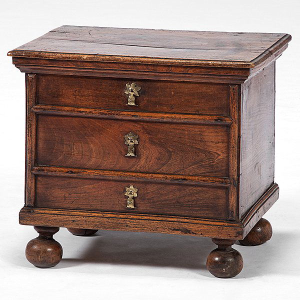 English Jacobean-Style Chamber Stand : English Jacobean-Style Chamber Stand English, late 19th century. A Jacobean-style oak chamber stand disguised as a miniature three-drawer chest on ball feet, having strap hinges and later brass tea