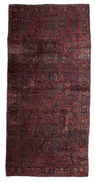 Sarouk Rug : Sarouk Rug Iran, ca 1930s. A Sarouk wool room-size rug, having a deep rose ground and a complex and dense floral field; 16.5 x 8 ft. (198 x 96 in., 502.92 x 243.84 cm).