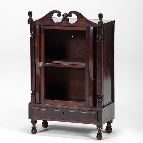 French Wall Shelf : French Wall Shelf French, 19th century. A wall shelf or cabinet in mahogany, having turned finials, a broken arch pediment, hinged door and interior shelf, on turned feet; ht. 33, wd. 20.5, dp. 1