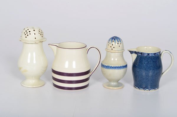 Creamware Jugs and Castors : Creamware Jugs and Castors English, 18th century. A group of creamware including two castors, one having blue glaze decoration, both unmarked, and two small jugs, one having mottled blue glaze, unma