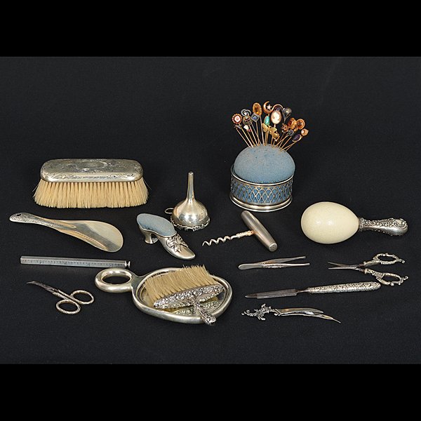 Assorted Sterling Accessories : Assorted Sterling Accessories American. An assembled group of fourteen sterling silver accessories, including two brushes, a darner, a mirror, two pin cushions, one in the shape of a shoe, a shoe h