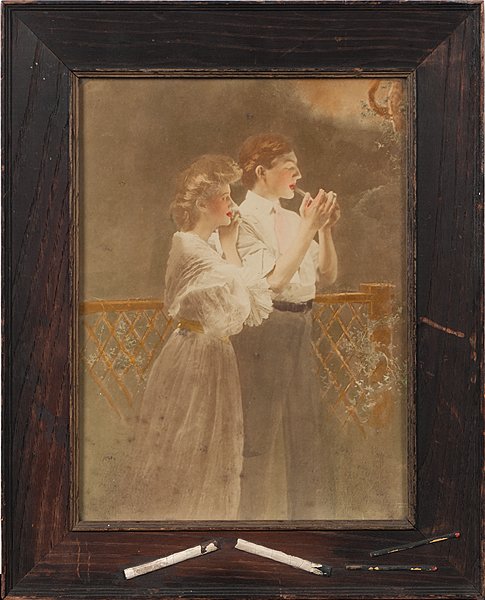 Cigarette Advertisement : Cigarette Advertisement Probably American, early 20th century. A tinted photograph of a couple, the young man lighting a cigarette while the lady, leaning on his shoulder, looks on wistfully. They 