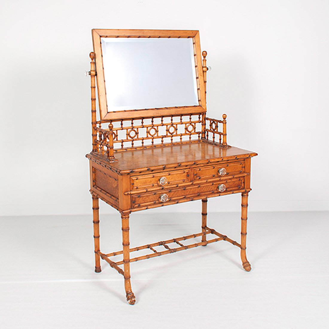 Faux Bamboo Vanity : Faux Bamboo Vanity American, 19th century. A bird's-eye maple vanity with faux bamboo turnings with three drawers, glass pulls, and pivoting framed mirror; ht. 60.5, wd. 36.25, dp. 19.5 in.