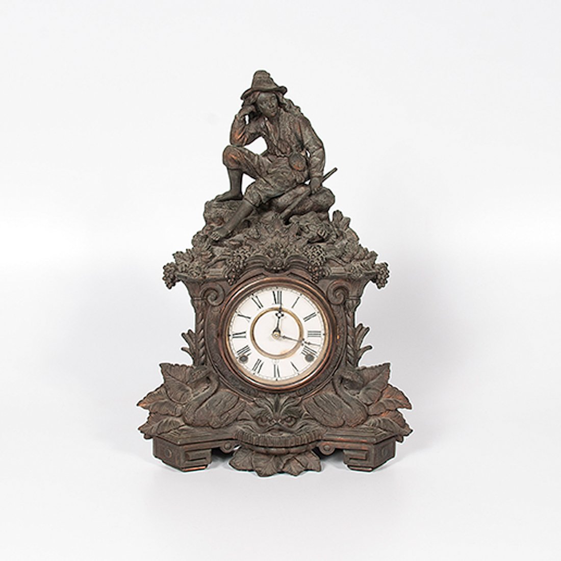 Cast Iron Figural Mantle Clock : Cast Iron Figural Mantle Clock Continental, late 19th century. A cast iron figural mantle clock with alarm decorated with peasant boy on top and two swans and fanciful face beneath clock face wit