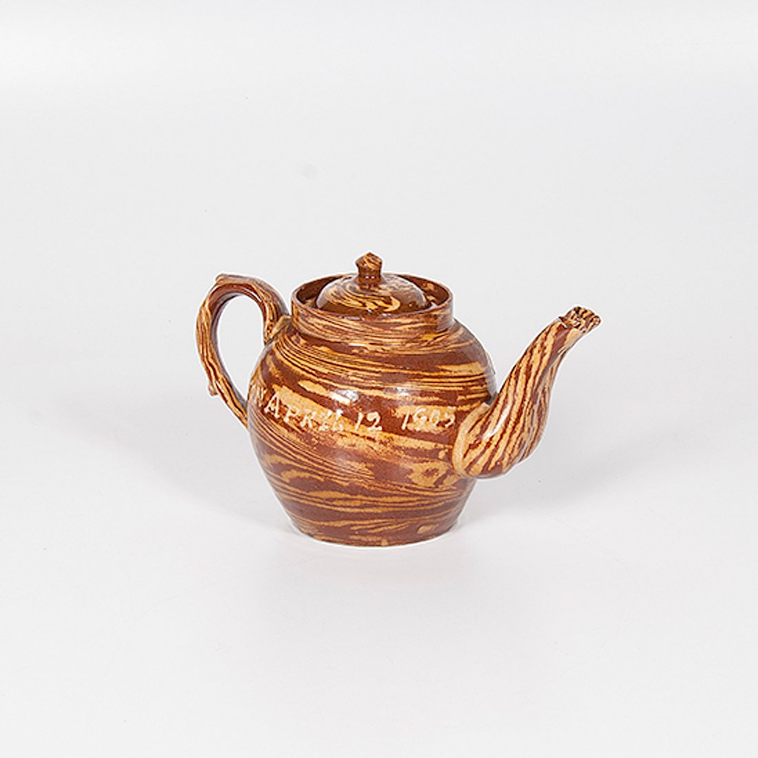 Double-Spout Agateware Teapot : Double-Spout Agateware Teapot English, early 20th century. An agateware teapot in red and yellow with double spouts, marked in slip around body Mrs G.C. Steele Accrington April 12 1905; ht. 6.75 i