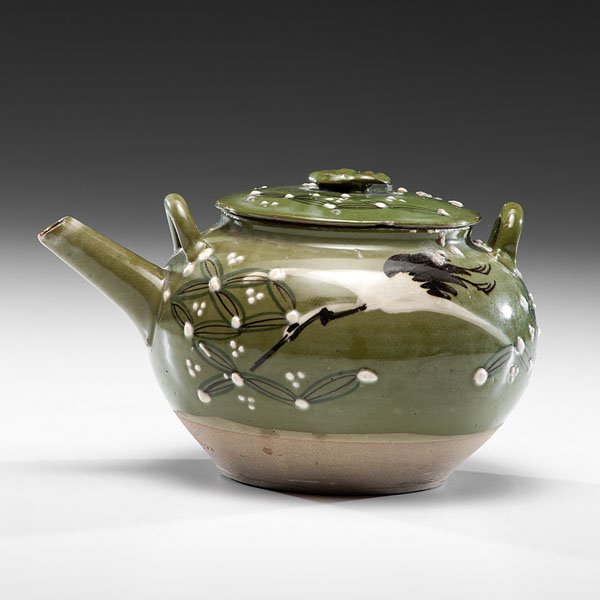 Earthenware Teapot with Green Celadon Glaze : Earthenware Teapot with Green Celadon Glaze Japanese, 20th century. An earthenware lidded and handled teapot covered in a green celadon glaze and decorated with crane and geometrical motifs. Ht. 5.5
