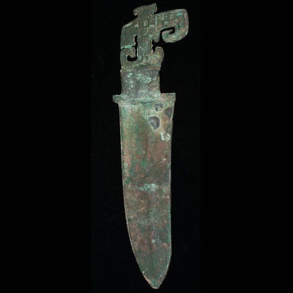 Western Zhou Bronze Knife : Western Zhou Bronze Knife Chinese, attributed Western Zhou. Archaic-form bronze knife, heavily oxidized and with archaic scrollwork to handle. Lg. 11.25 in.