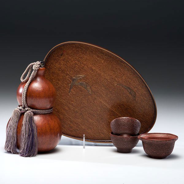 Japanese Double-Gourd Sake Flask, Wood Tray, and: Japanese Double-Gourd Sake Flask, Wood Tray, and Earthenware Sake Set Japanese, second quarter 20th century. A Hyotan or natural double-gourd sake flask with metal plug and tassel, a wood and lacque