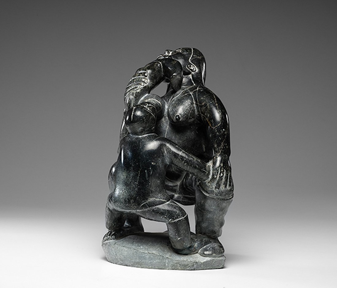 Inuit Mother and Child Stone Sculpture : Inuit Mother and Child Stone Sculpture unsigned; strong imagery of a squatting mother chewing a kamik and breastfeeding her child, height 21 in. x length 12 in. x width 13 in. 20th century