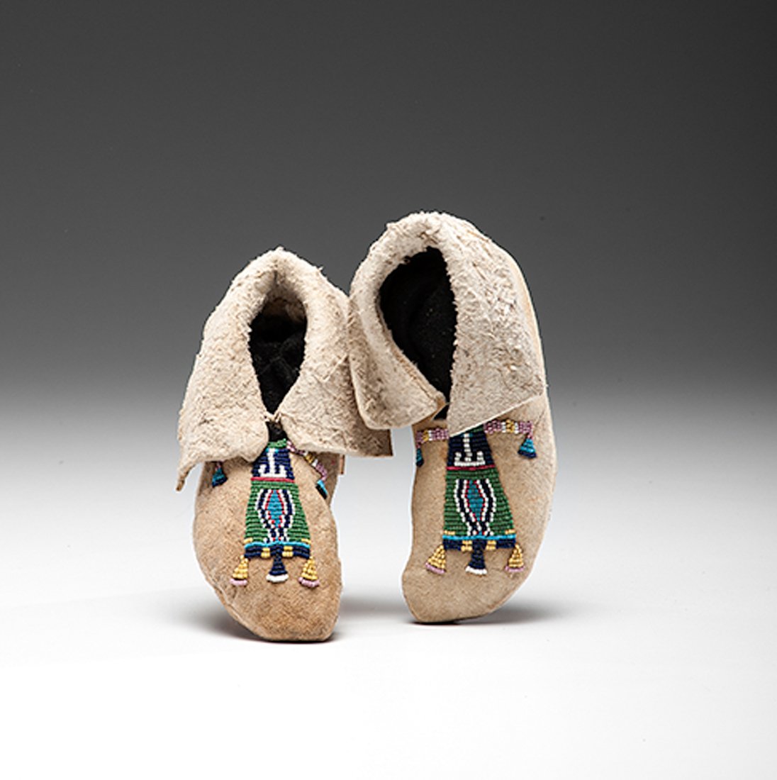 Plateau Child's Beaded Hide Moccasins, : Plateau Child's Beaded Hide Moccasins, possibly Crow, thread-sewn on elk hide using colors of red white-heart, pink, light blue, pea green, and greasy yellow, length 6.5 in. late 19th century