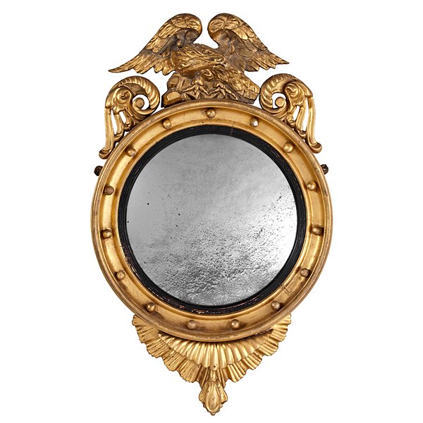 Federal Giltwood Mirror : Federal Giltwood Mirror American, 19th century. A round convex mirror with gilt and ebonized wood frame accented with spherules and surmounted by a carved eagle crest; ht. 39.75, wd. 23.5 in.
