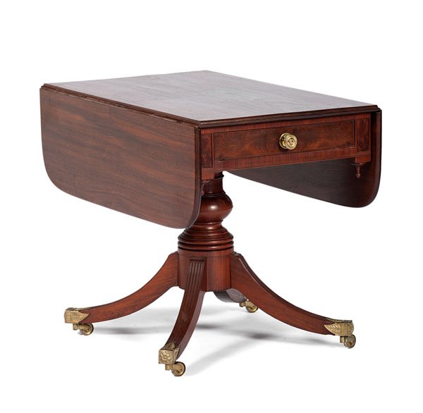 Duncan Phyfe-Style Drop Leaf Table : Duncan Phyfe-Style Drop Leaf Table American, 20th century. A drop leaf table in mahogany on turned baluster support and four reeded, out-swept legs with brass terminals and casters; ht. 29, wd. 23