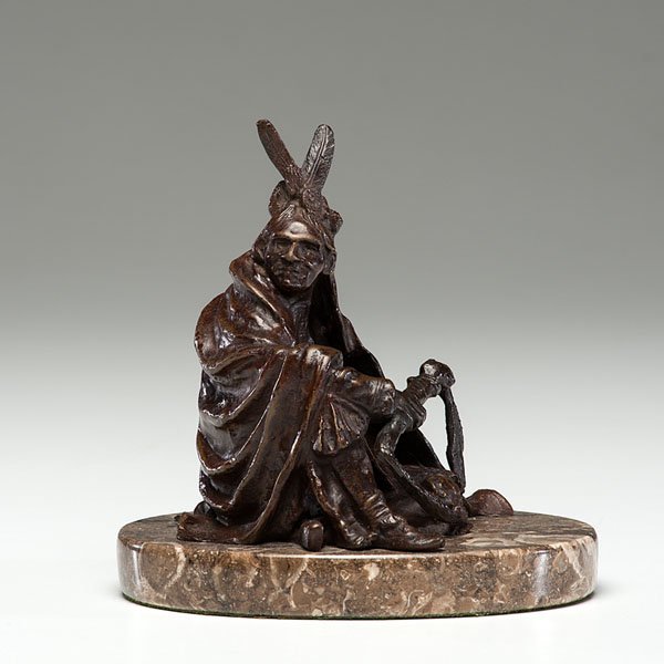 Bronze Indian by Carl Kauba : Bronze Indian by Carl Kauba Carl Kauba (Austrian, 1865-1922). Bronze on marble base, depicting seated Indian, signed on figure; ht. 6.5 in. (w/base).
