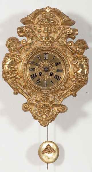 German Brass Wall Clock : German Brass Wall Clock German (South), late 19th century. A wall clock with a brass repoussé case with an urn of flowers at top, putti on sides and grotesque on bottom, thirty-hour time and strik