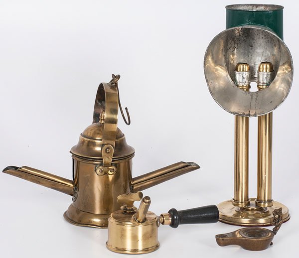 Assorted Brass Lighting : Assorted Brass Lighting 19th century. An assembled group of brass lighting pieces including a betty lamp with figural handle and mask incised reservoir, a brass basin torch with wooden handle, a dou