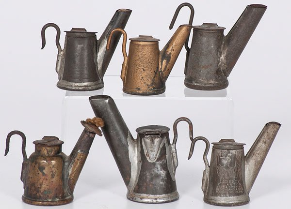 Oil Miner's Lamps : Oil Miner's Lamps American, late 19th-early 20th century. An assembled group of six tin miner's hat lamps or oilwick spout lamps, all with stamped labels; largest ht. 3.75 in.