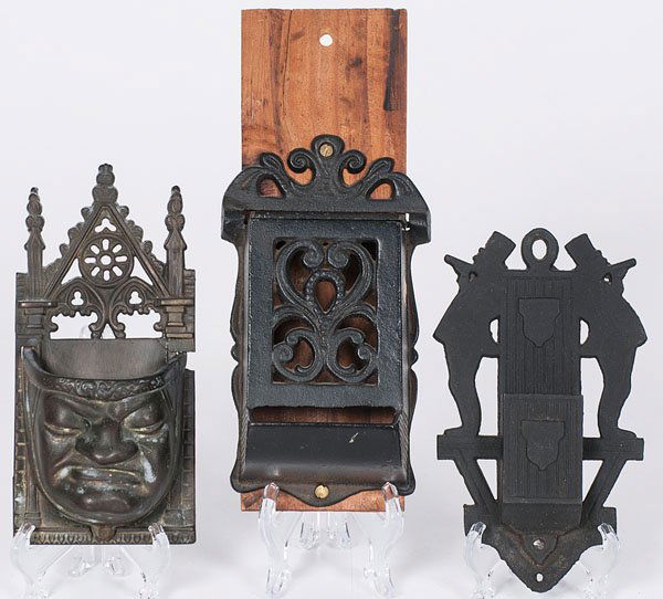 Cast Iron Match Safes : Cast Iron Match Safes 20th century. A group of three cast iron match safes, each with wall mount and stamped with style number. One lidded and pierced with scrollwork, one with mount featuring two m