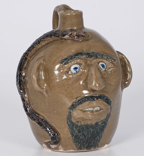 Face Jug with Snake by Jerry Brown : Face Jug with Snake by Jerry Brown Jerry Brown (Alabama, b. 1942). A face jug in green glaze with applied and incised snake, incised on underside 4-93/Jerry Brown/Hamilton/AL; ht. 10.25 in.