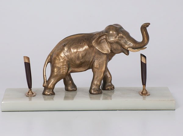 Gold Plated Pen Stand : Gold Plated Pen Stand American. A gold plated figural desk accessory in the form of an elephant flanked by two gold and metal pen holders, all on a marble base; ht. 7.5, wd. 15, dp. 6 in.